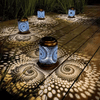 Outdoor Solar Garden Lantern illuminating a wooden deck with intricate patterns at night.