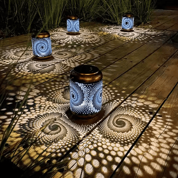 Outdoor Solar Garden Lantern illuminating a wooden deck with intricate patterns at night.