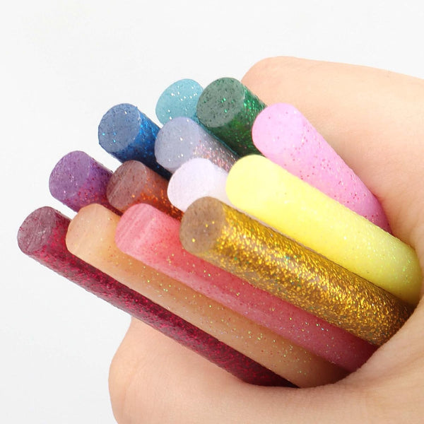 Colored Hot Glue Stick Set for DIY Crafts and Decorations in vibrant colors held in a hand.