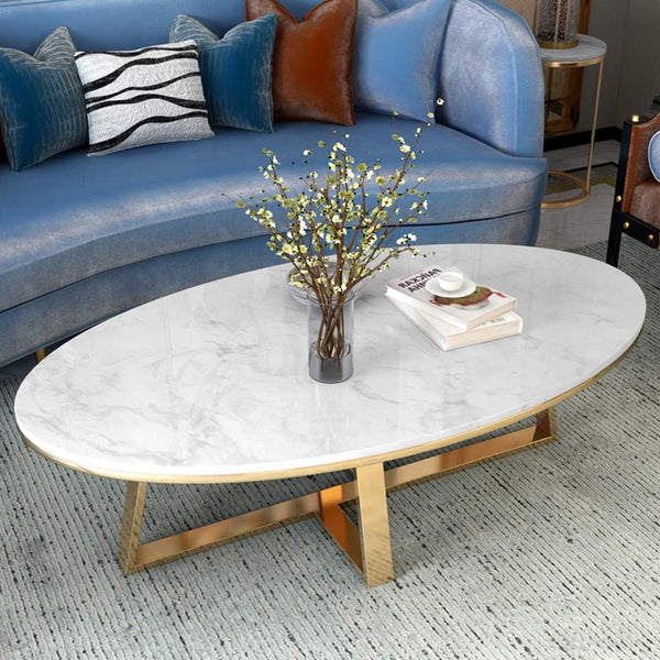 Oval Faux Marble Coffee Table with Gold Metal Base elegantly displayed in a modern lounge setting.