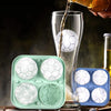 Sports Ice Ball Molds in football and basketball shapes filling a glass with beverage.