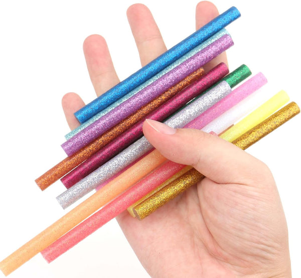 Hand holding a variety of colorful glitter hot glue sticks from the Colored Hot Glue Stick Set for DIY Crafts and Decorations.
