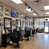 Inside view of a modern barbershop showcasing multiple Heavy Duty Hydraulic Barber Chairs and well-organized workstations.