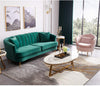 Oval Faux Marble Coffee Table with Gold Metal Base in a stylish modern lounge setting with a green velvet sofa and pink chair.