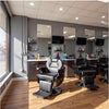 Interior of a modern salon showcasing Heavy Duty Hydraulic Barber Chairs and professional hair care products.
