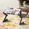Adjustable Laptop Desk with an open book on it, showcasing ergonomic design for studying or working comfortably.