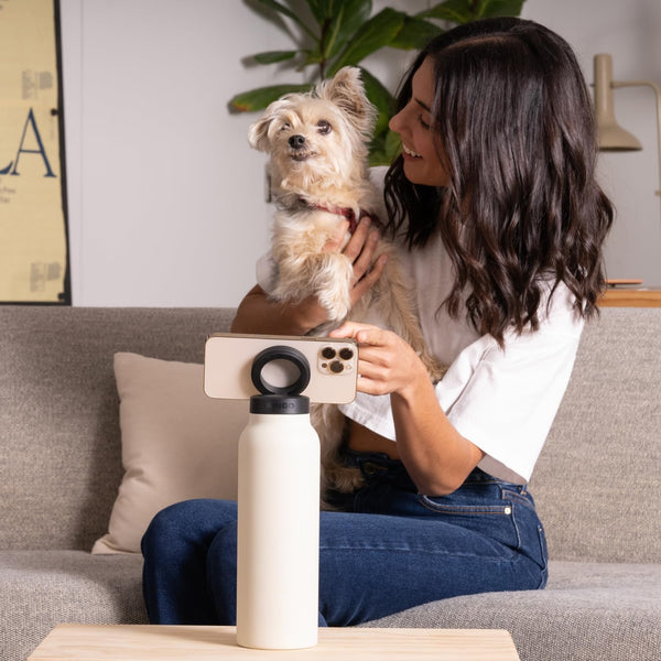 Magnetic MagSafe Insulated Sports Water Bottle with smartphone and dog, perfect for hands-free use