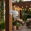 1080P Outdoor PTZ Wi-Fi Security Camera mounted on a wooden post in a cozy outdoor setting.