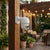 1080P Outdoor PTZ Wi-Fi Security Camera mounted on a wooden post in a cozy outdoor setting.