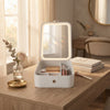Portable Cosmetic Organizer with LED Mirror on a wooden table with a mirror and beauty products.