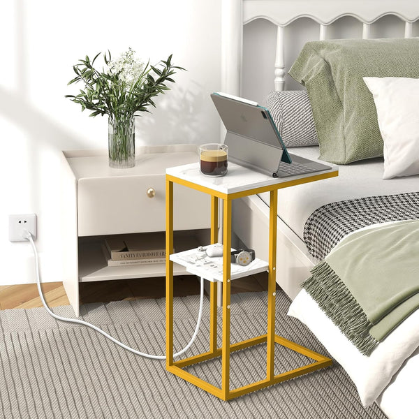 C Shaped Side Table with Charging Station next to a bed, featuring a tablet and coffee, designed for convenience.