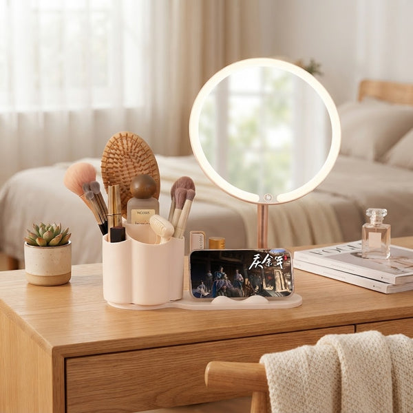 LED Makeup Mirror with Rotating Cosmetic Organizer on a wooden vanity with makeup brushes and phone stand.