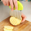 A hand using a Crinkle Cutter Chopping Tool Slicer to create crinkle-cut shapes on a potato.