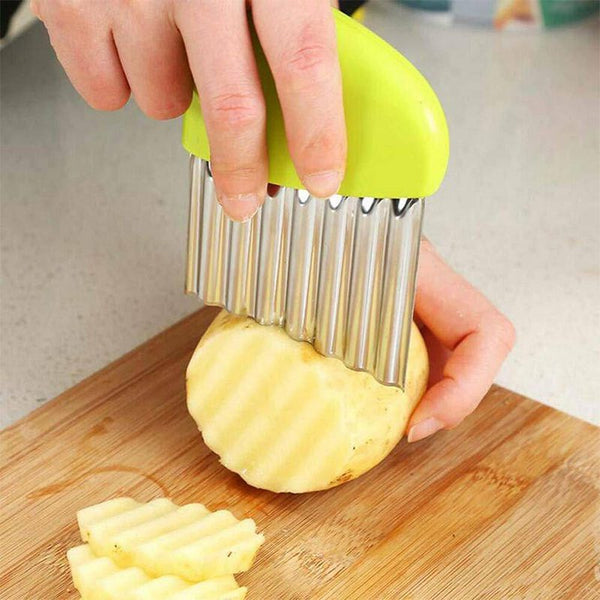 A hand using a Crinkle Cutter Chopping Tool Slicer to create crinkle-cut shapes on a potato.
