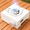 Compact Outdoor Gas Camping Stove on a wooden surface with blue flames rising from the burner.