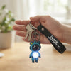 Colorful Astronaut Bear LED Keychain with Wrist Strap illuminating keys in hand.