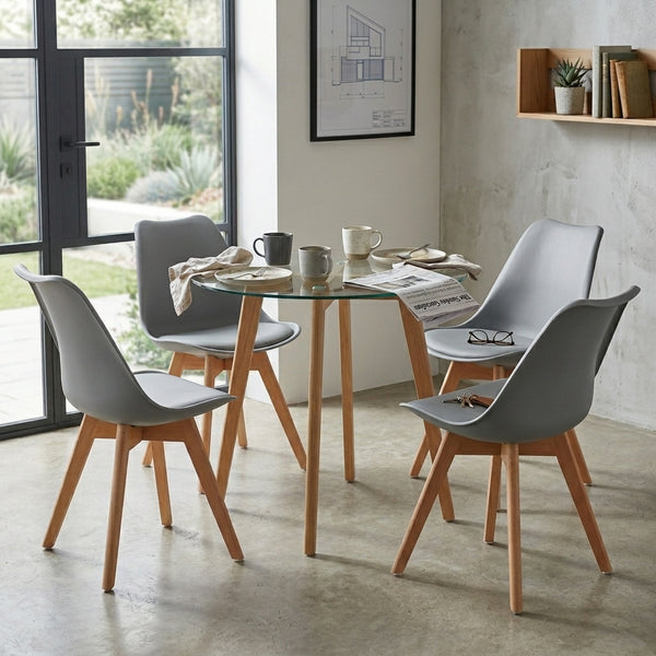 Round Glass 5 Piece Dining Set with Fabric Chairs featuring stylish gray chairs and a glass table in a modern setting.