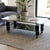 Coffee Table with Glass Top - Black showcased in modern living room with stylish decor and plant.