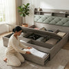 Woman organizing bedding in Solid Wood Storage Bed Frame with modern design and built-in under-bed storage.