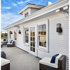 Glow Square Outdoor Wall Light mounted on modern white exterior wall, illuminating outdoor seating area.
