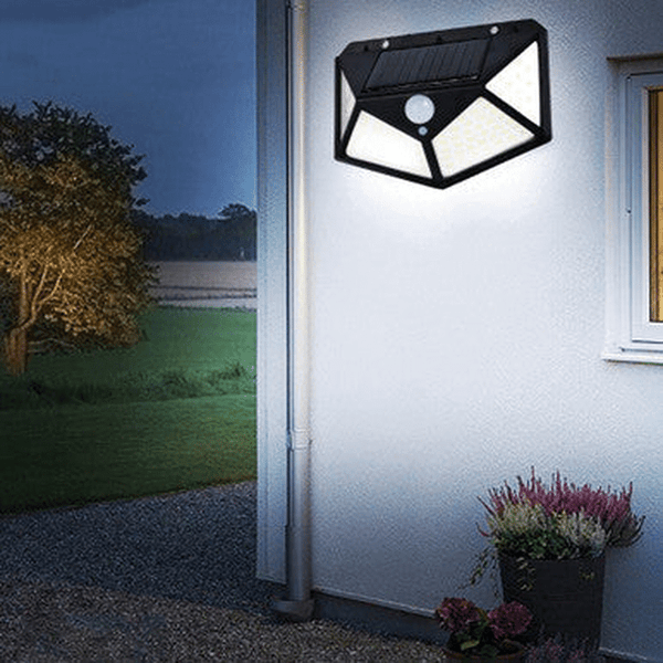 114 Solar Motion Sensor LED Wall Light mounted on a wall, illuminating outdoor space in the evening.