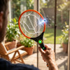 Person using a Rechargeable Electric Mosquito Killer Racket Fly Swatter to eliminate flies indoors.