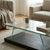 Modern Glass Top Coffee Table featuring clear glass and dark wood-look base in a stylish living room setting.