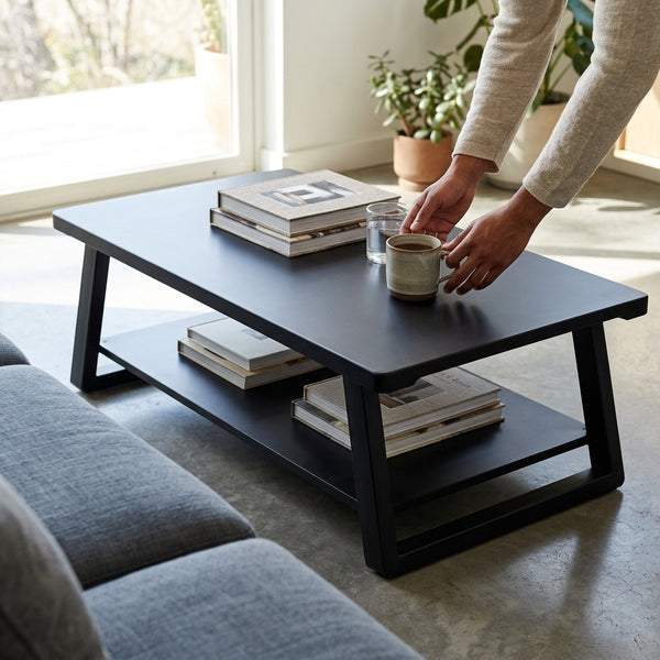 Industrial Minimalist Wood & Metal Coffee Table in a modern living room with books and coffee cup.