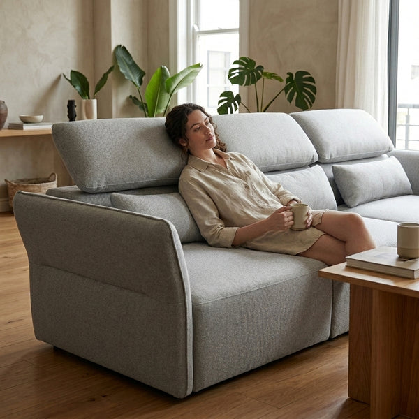 SF-622B Modular Fabric Couch in a cozy living room, featuring adjustable headrests and a relaxed female sitting comfortably.
