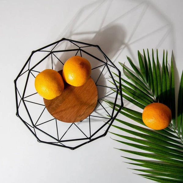 Geometric Iron Fruit Storage Basket with oranges and wooden base on a clean background.
