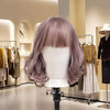 Wood Mannequin Head Wig Display Stand showcasing a stylish purple wig in a boutique setting.