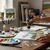 Acrylic Paint 75ml - Vandyke Brown being used in a cozy artist's studio with paint palettes and brushes.