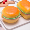 Adorable Burger-Style Double Layer Kids Lunch Box Container in fun, burger shape on a tray with kitchen items.