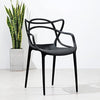 Cafe Replica Master Chair in black against white wall with a plant in a pot.