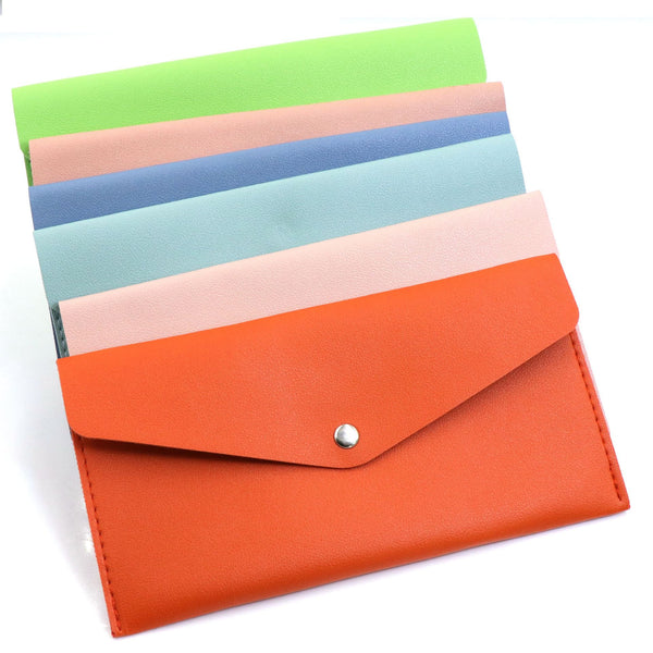 Candy colored makeup brush set pouches in vibrant colors including green, orange, and blue.