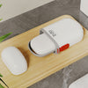 Compact Waterproof Travel Soap Case with Carry Handle placed on wooden surface next to soap bar.