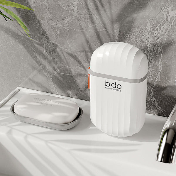 Compact Waterproof Travel Soap Case with Carry Handle on a bathroom countertop.