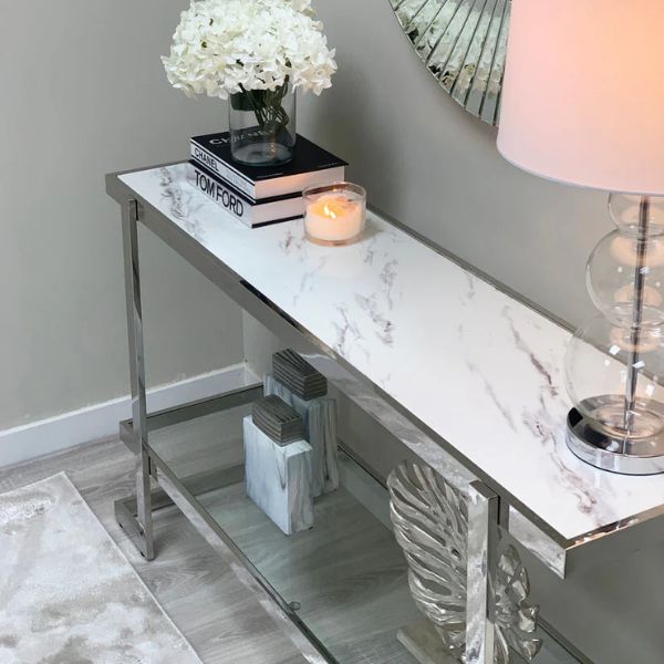 Stylish Double Tier Silver Console Table with marble top and decorative items in a modern living space.
