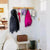Wooden Wall-Mounted Coat Rack holding coats, helmets, and bags in a stylish entryway, ideal for home organization.