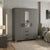 3-Door Grey Wooden Wardrobe with Mirrored Center & 3 Drawers in a modern bedroom setting.