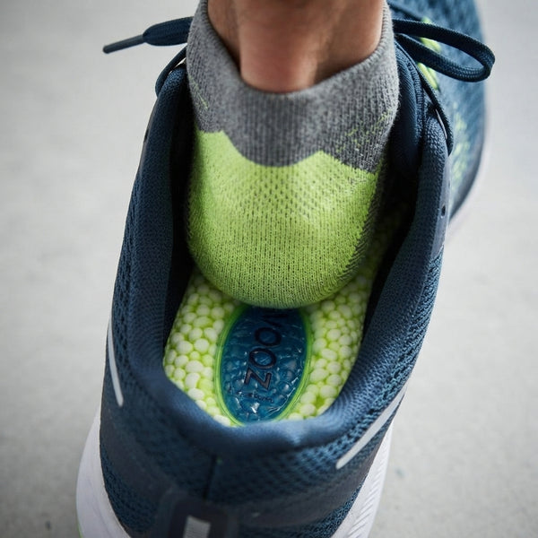 Cushioned Comfort Insoles inside a running shoe, showcasing textured surface and cushioned support for enhanced comfort.
