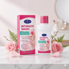 Natural pH Balanced Rose Intimate Wash in a bottle with box and rose petals on a marble surface.