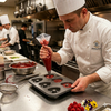 Chef using Non-Stick Heart Shaped 6-Cup Muffin Tray to fill with batter in a professional kitchen.