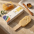 Painless Honey Hard Wax Block with honeycomb and wooden stick on a marble surface.