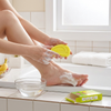 Person using Beauty Banana Milk Mini Whitening Soap for foot care in a bathroom setting.