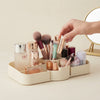 Multi-Compartment Desktop Storage & Organiser Tray with cosmetics and brushes on a desk.