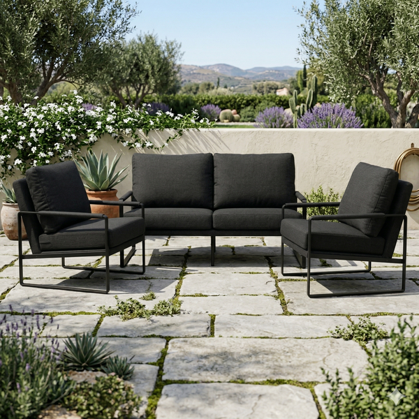 3-Piece Outdoor Patio Set featuring a stylish black cushion sofa and chairs on a stone patio surrounded by greenery.