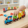 Child playing with the Number Train Wooden Counting Set featuring colorful train pieces and numbers.