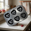 Non-Stick Heart Shaped 6-Cup Muffin Tray showcasing six heart-shaped cavities on a kitchen countertop.