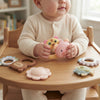 Baby Sensory Rattle & Teether Toy Set featuring colorful animal shapes for infants on a wooden table.